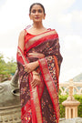 Alluring Brown And Orange Patola Silk Saree