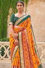Alluring Orange And Green Patola Silk Saree