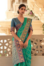 Teal Green Zari Woven Patola Design Saree With Blue Blouse